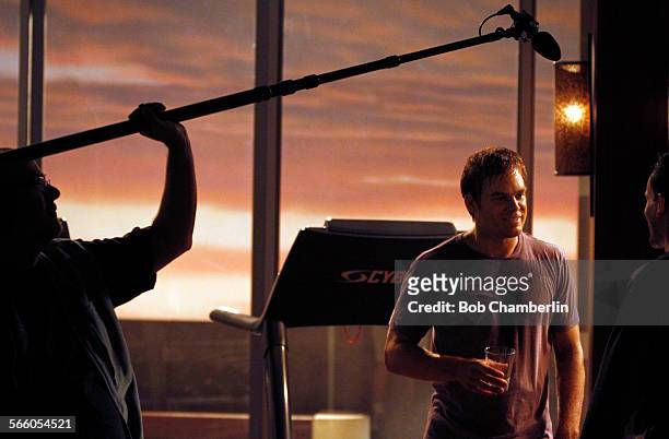 Michael C. Hall, "Dexter" and guest star Jonny Lee Miller talk during scene while filming in the gym on the set of Dexter on SEPTEMBER 14, 2010.