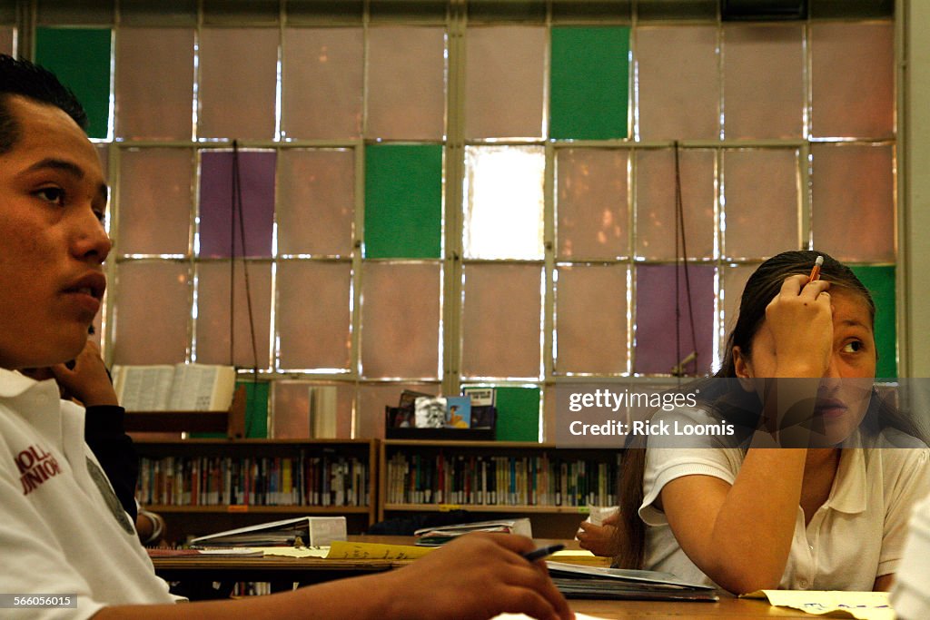 Enrique Olguin, 12, and Ashley Atayde, 12, sit in their 8th grade class at Hollenbeck Middle School