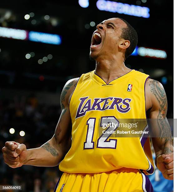 Lakers guard Shannon Brown screams out in elation after making a slam dunk over Nuggets defender Chris Andersen in the second half of game five of...