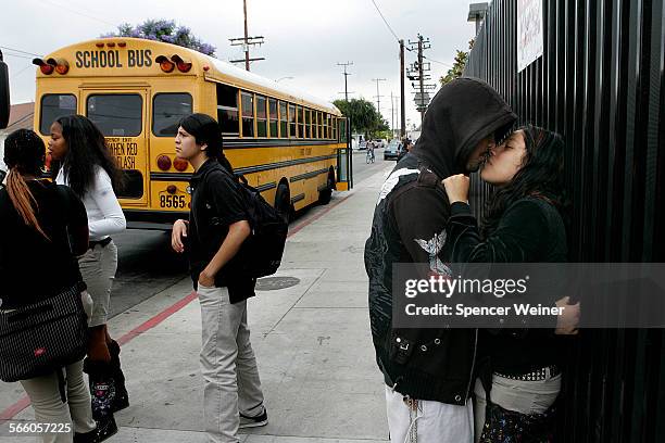 Locke High School students Cassandra Garcia with her boyfriend Salvador Picas meet up after school as a bus prepares to leave campus. The bus routes,...