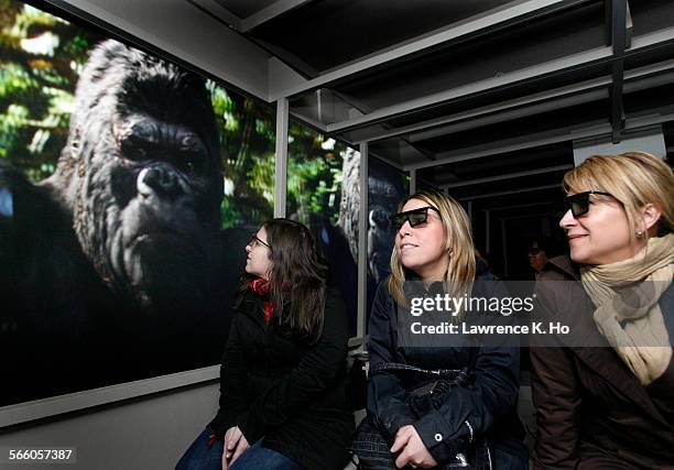 Jamie Glastein, Jenn DeCrescenzo and Sheri Bain with 3D glasses during a short tour of a test version of The KIng Kong ride setup inside a hangar for...