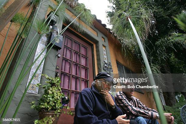 Small businessmen Jeff Serber, right, and his father David sit surrounded by new landscaping they added, in front of one of their units with original...