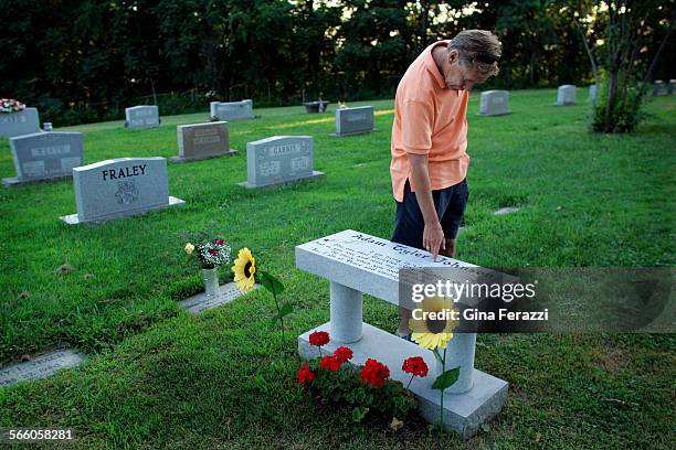 Teddy Johnson always traces his fingers along his son's name before leaving the gravesite at Spring Hill Cemetery. Johnson found his son Adam dead of...