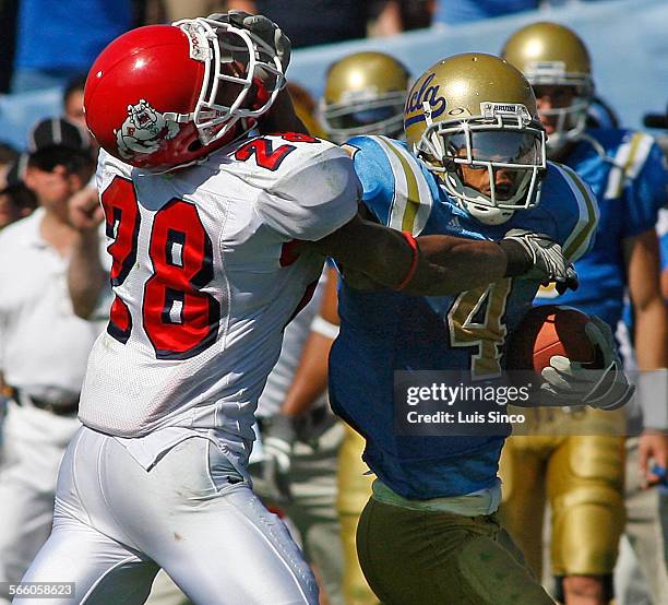 Kick returner Terrence Austin stiffarms Fresno State defensive back A.J. Jefferson during a big return to open the second half Saturday, Sept. 27 at...