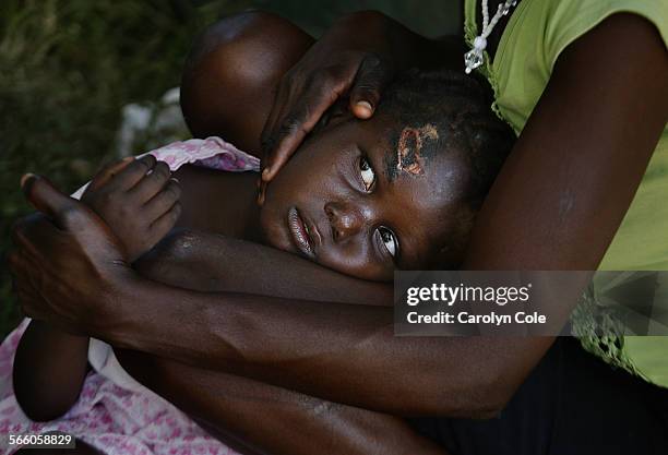 Nearly one week after the earthquake struck Haiti, Seraphine Joseph, age 2, is still waiting to be cared for at a clinic in Leogane.