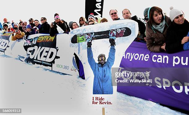Picture of Kevin Pearce who was injured during competiton last week sits in the snow as fans watch a snowboarding competition in Mammoth.