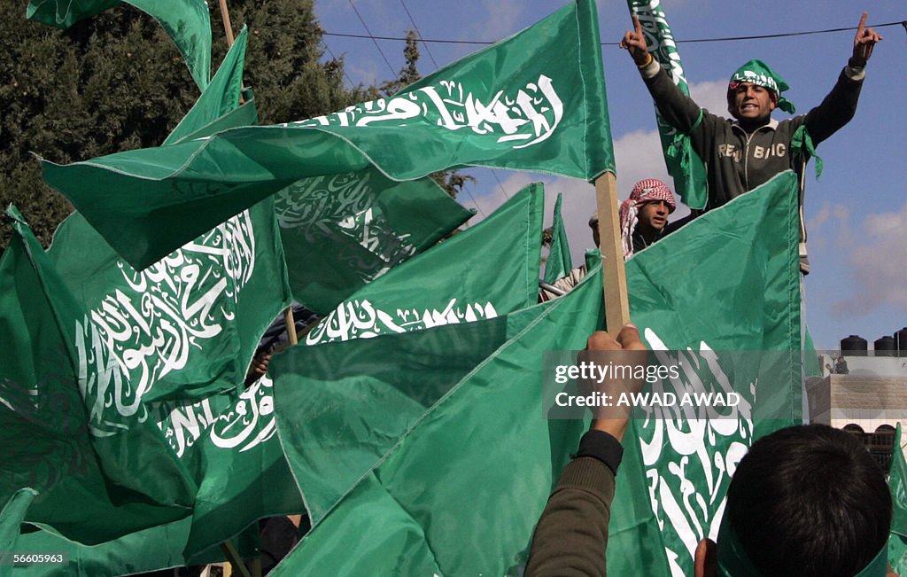 Palestinians wave flags from the militan
