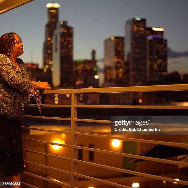 The "Rainbow" resident Nia Layton looks from her walkway across the "Abby" to the panorama of Los Angeles downtown at dusk. The "Rainbow" and the...