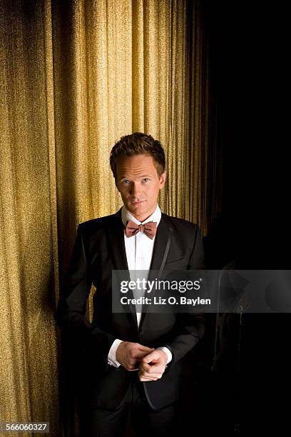 Neil Patrick Harris wears a Louis Vuitton tuxedo, Dolce and Gabbana shirt, Bottega Veneta bow tie and cuff links, and Arfango shoes for a photo shoot...