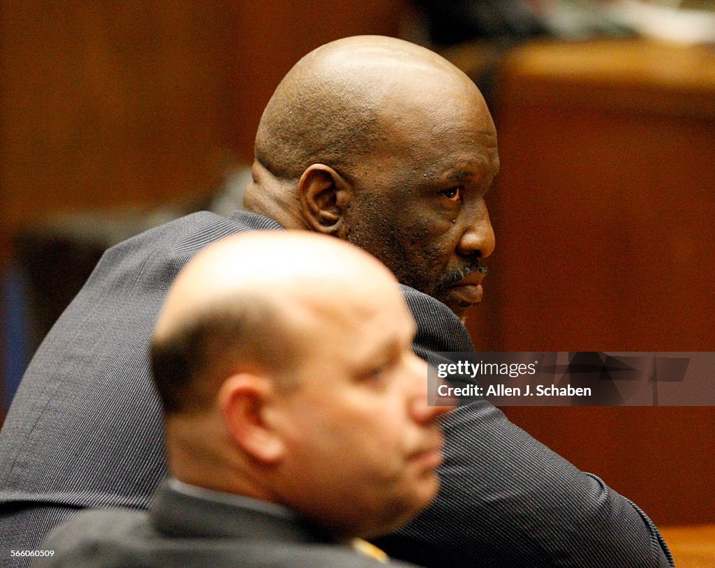 With defense attorney Sean McDonald, in foreground, listening, Ernest V. Nelson, 51, in focus, is f