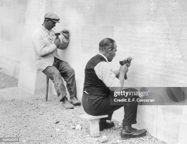 Workmen put the finishing touches to the names inscribed on the Canadian National Vimy Memorial in France, September 1930. The names commemorate the...