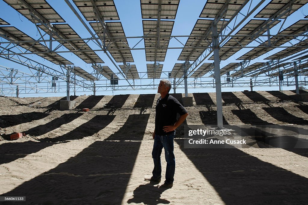 PR rep Rich Schineller stands underneath a five acre solar field below which will be a four acre ra