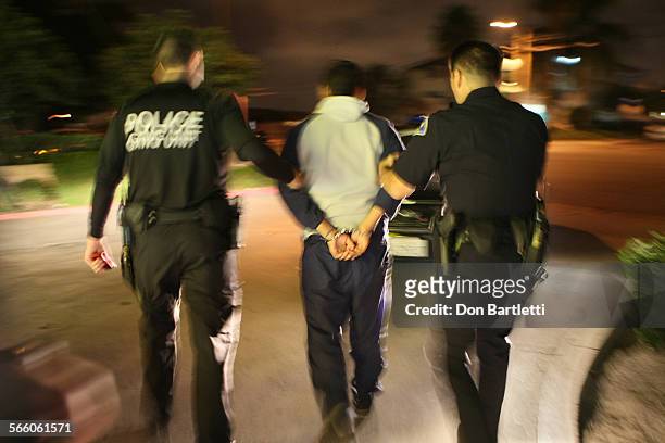 Anaheim Police Sgt. Mike Haggerty and his partner and Investigator Brian Browne guide a 17yearold boy to their squad car. The teen was spotted at...