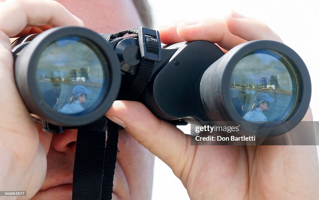 AUGUST 27, 2008. LONG BEACH, CA. Reflected in the binoculars of Dr. Lance Adams, staff vet at the A