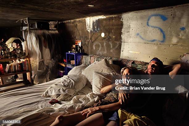 Steve, right, and his girlfriend Kathryn lie in their queen-size bed in a storm drainage tunnel under the city of Las Vegas where they have one of...