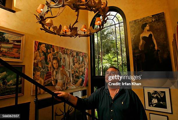 An antler chandelier hangs over Turner's, light filled foyer which features an eclectic melange of artwork: vintage cowboy paintings, blackandwhite...