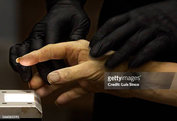 Lance Cpl. Robert Norton Marietta, Ga., fingerprints a corpse that was delivered to the Los Angeles County Coroner's morgue in Boyle Heights. The...