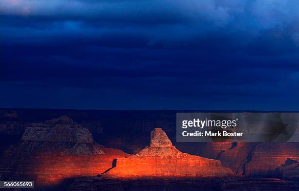 Looking East, the tops of the rock formations are glowing with color during sunset Mohave Point in the Grand Canyon December 13, 2008.The...