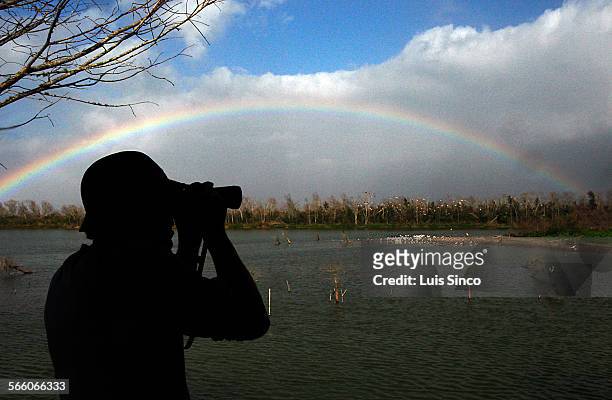 Rainbow forms over Clay Bottom Pond at Smith Oaks Bird Sanctuary in High Island, Tex. The area is a popular destination for bird watchers who flock...