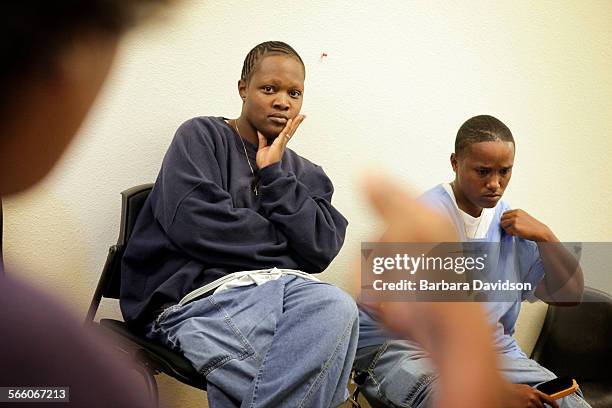 At the Valley State Prison for Women in Chowchilla, LaSonya Wells and Karima Holloway listen to fellow inmate Gina Tatum talk about budget cuts to...