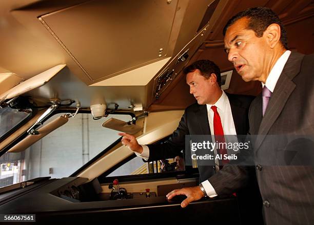 Metrolink Board Chairman Keith Millhouse, left, shows Los Angeles Mayor Antonio Villaraigosa the two inwardfacing cameras and one outwardfacing...