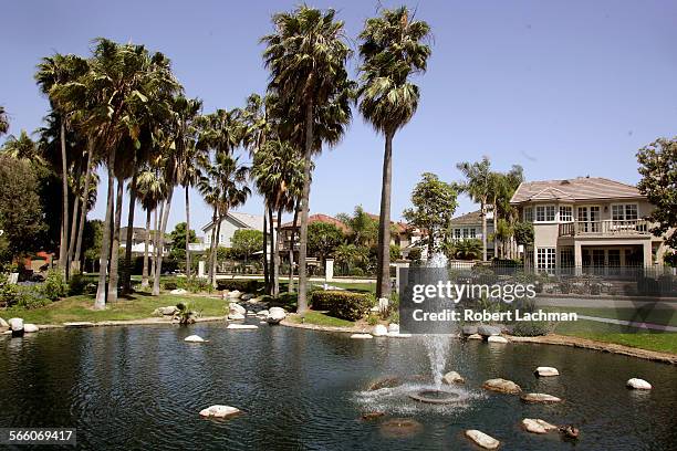 Homes along the border of a very small lake in the SeaCliff on the Greens development in the Huntington SeaCliff communtiy of Huntington Beach was...