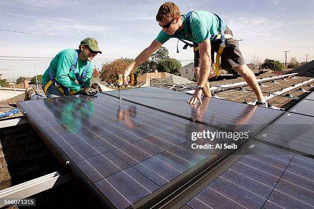 Joey Ramirez and Taran Stone with Solarcity install solar modules on the roof of a Long Beach home owned by Michelle Gerdes on Thursday morning....