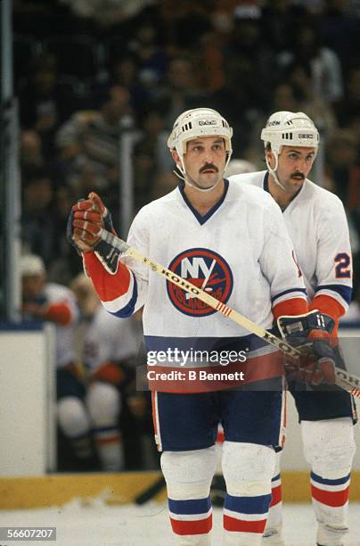 Canadian professional hockey player Bryan Trottier of the New York Islanders on the ice during a home game, Uniondale, New York, 1980s. His teammate...