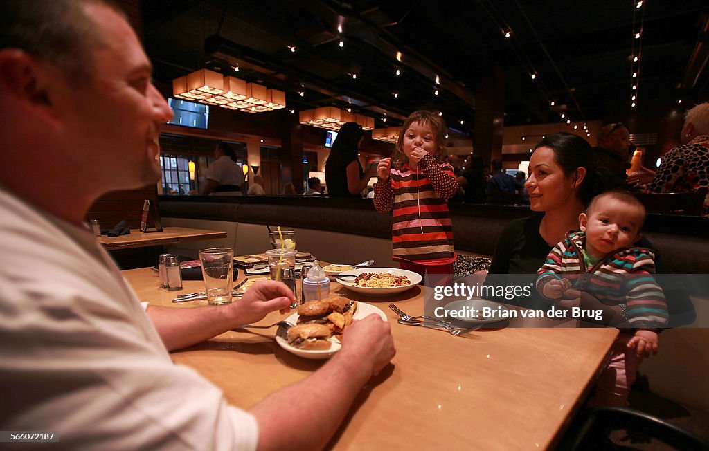 Adolfo Navarro, left, of Inglewood, enjoys a night out with his wife Sandra and kids Isabella, 3, l