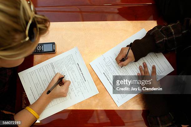 Bronte Cox left, from Van Nuys, and Bernice Rivera from Panorama City, work on job applications at the Westfield Fashion Square in Sherman Oaks, Feb....