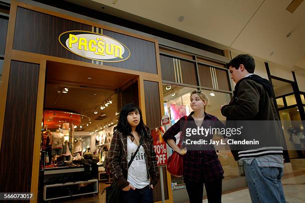 Bernice Rivera from Panorama City, left, Bronte Cox from Van Nuys, and Walter Donley from Van Nuys, right, checked in at more than six stores,...