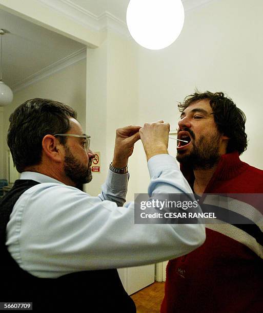 Genetic investigator Francesc Albardaner of the Colombins del Cultural Omnium takes a saliva sample from Jaume Colom Escayola to analyse his DNA in a...