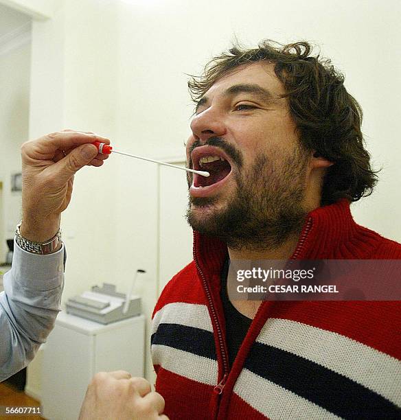 Genetic investigator Francesc Albardaner of the Colombins del Cultural Omnium takes a saliva sample from Jaume Colom Escayola to analyse his DNA in a...