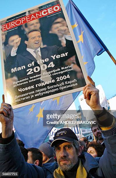Serbia Movement's supporter holds a picture of Serbia's richest tycoon and leader of the party Bogoljub Karic, during a rally in downtown Belgrade,...