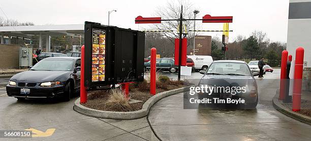 Two cars in two separate drive-up lanes place orders at a McDonald's drive-thru location January 17, 2006 in Rosemont, Illinois. McDonald's,...