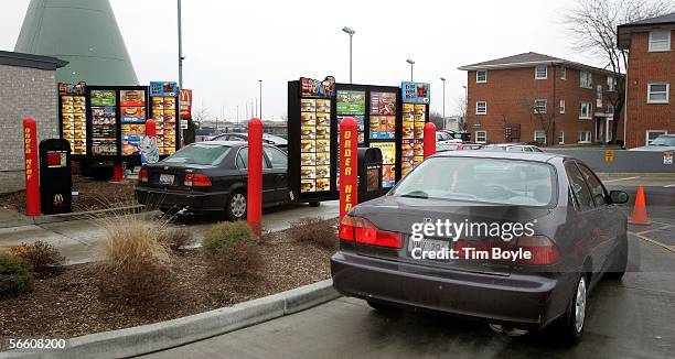 Vehicles in two separate drive-up lanes place orders at a McDonald's drive-thru location January 17, 2006 in Rosemont, Illinois. McDonald's,...