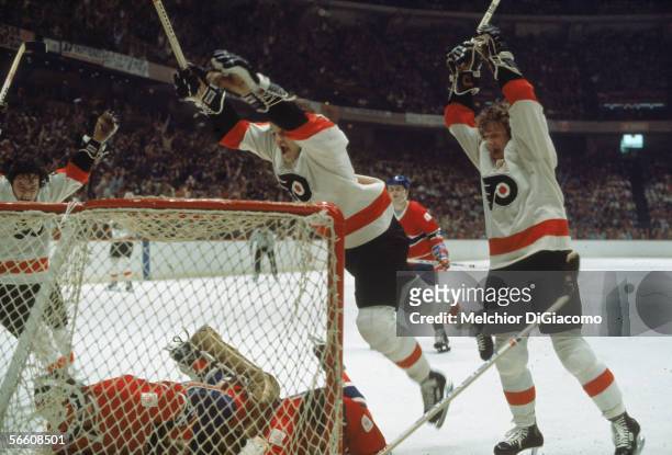 Canadian pro hockey players Bobby Clarke, Bill Barber and Reggie Leach of the Philadelphia Flyers celebrate a goal against the Montreal Canadiens,...
