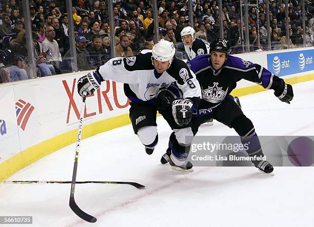 Martin Cibak of the Tampa Bay Lightning tries to keep the puck from Mike Weaver of the Los Angeles Kings on January 17, 2006 at Staples Center in Los...