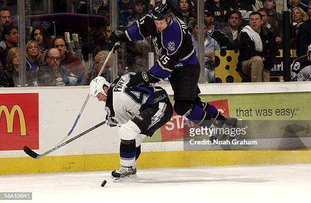Jeff Cowan of the Los Angeles Kings leaps over Nolan Pratt of the Tampa Bay Lightning on January 17, 2006 at the Staples Center in Los Angeles,...