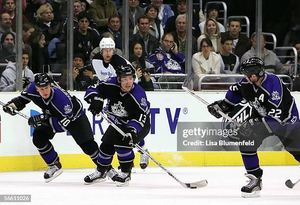 Michael Cammalleri of the Los Angeles Kings carries the puck alongside teammates Craig Conroy and Nathan Dempsey during the game against the Tampa...