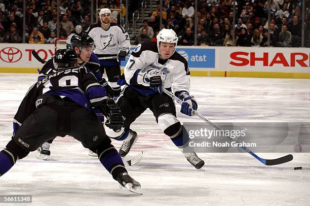 Ruslan Fedotenko of the Tampa Bay Lightning brings the puck up the ice against Nathan Dempsey and Michael Cammalleri of the Los Angeles Kings on...