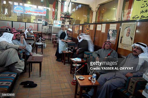 Kuwaitis smoke the narghile at a traditional coffee shop in downtown Kuwait City 18 January 2006, after companies and shops resumed business as usual...