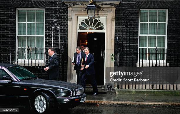 Britain's Prime Minister Tony Blair gets in a car as he departs Downing Street watched by police officers and security officials on January 18, 2006...