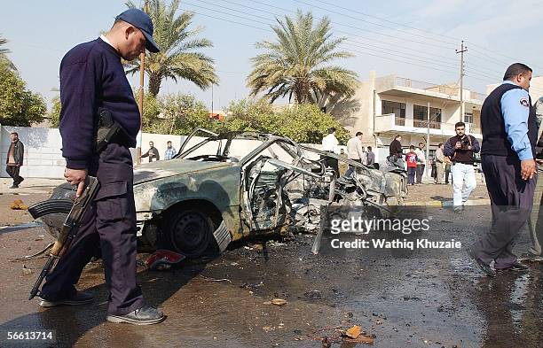Iraqi policemen secure the site of a car bomb explosion on January 18, 2006 in Baghdad, Iraq. A car bomb exploded in Karada district central of...