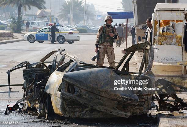 An Iraqi solider secures the site of a car bomb explosion on January 18, 2006 in Baghdad, Iraq. A car bomb exploded in Karada district central of...