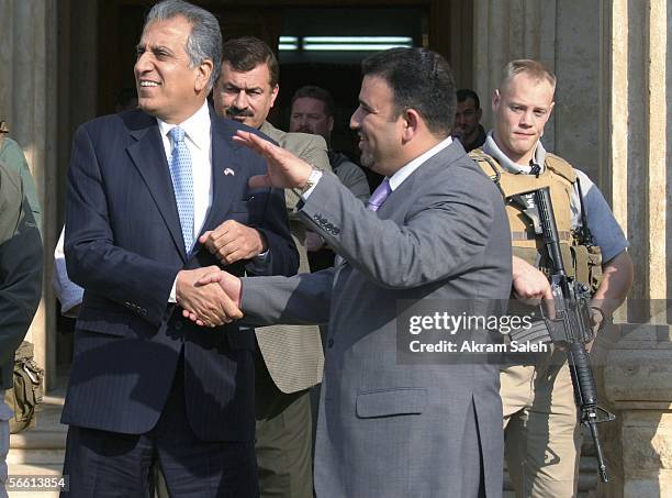 Zalmay Khalilzad the U.S ambassador to Iraq shakes hands with Muhammad Al-rubaee the head of the local council of Baghdad's Karada district, during a...