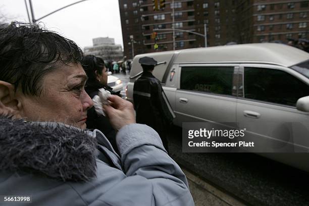 Woman cries while looking at the hearse carrying the body of Nixzmary Brown after her funeral January 18, 2006 in New York City. Brown was found...