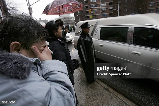 Woman cries while looking at the hearse carrying the body of Nixzmary Brown after her funeral January 18, 2006 in New York City. Brown was found...