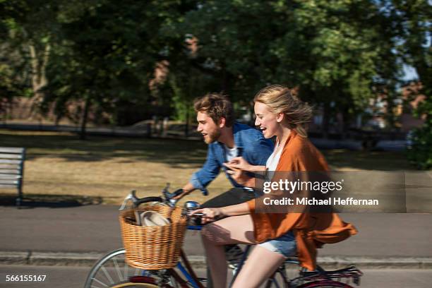 couple cycling in park - bicycle basket stock pictures, royalty-free photos & images