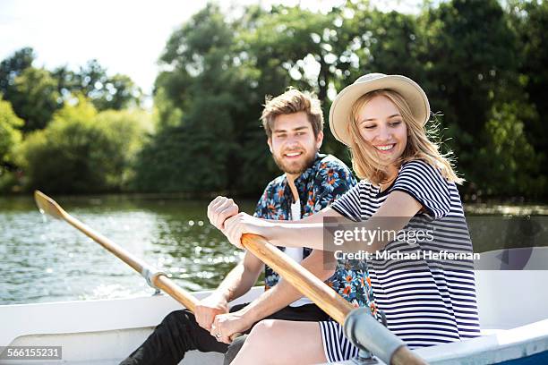 couple rowing boat on lake - couple london stockfoto's en -beelden